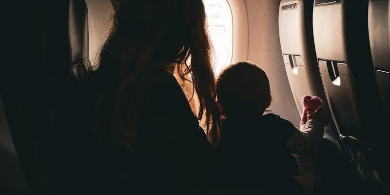 Mother and child looking out an airplane window