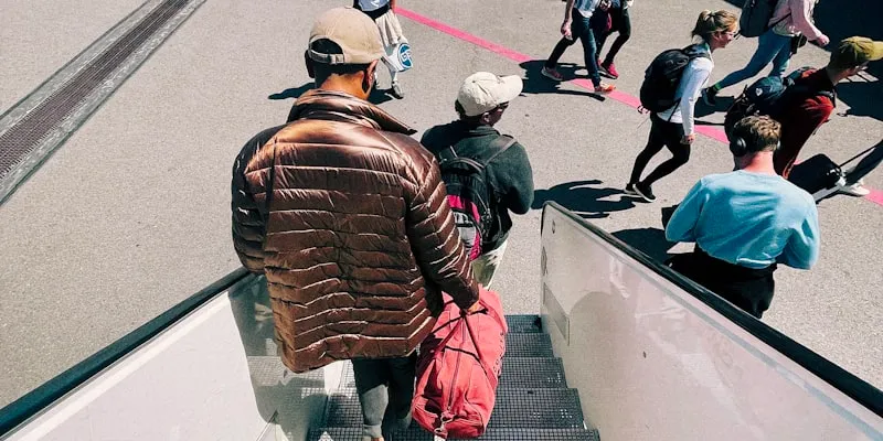 Passengers boarding an airplane via stairs on the tarmac
