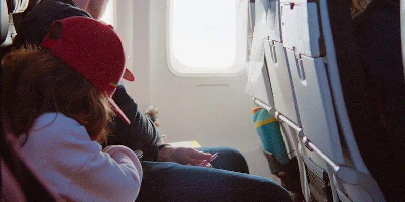 Passengers seated inside an airplane cabin during a flight